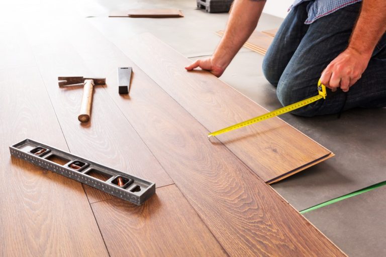 man installing wooden flooring