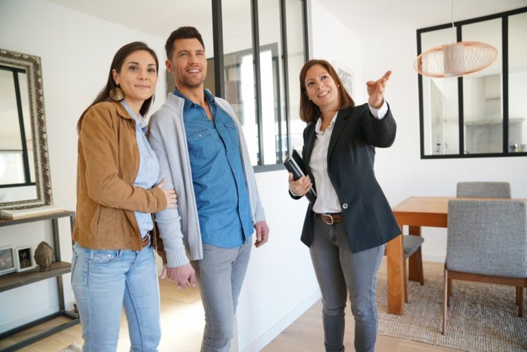 Real estate agent touring the couple around the house