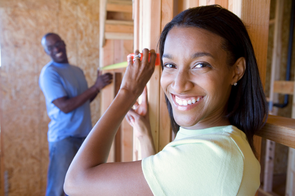 happy homeowners inside a house under construction