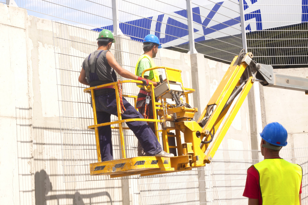 two workers in hydraulic mobile platform